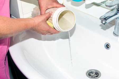 Female hands are washing the flask for water filters. The process of replacing cartridges of a multi-stage water filter.の写真素材