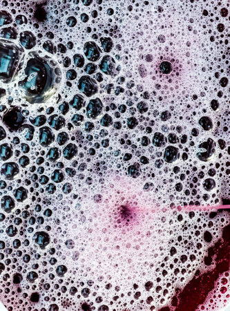 The process of making homemade grape wine. The operation of a hydraulic press to obtain grape juice for fermentation. Close-up of freshly squeezed grape juiceの写真素材