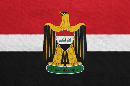 Flag and coat of arms of the Republic of Iraq on a textured background. Concept collage.の写真素材