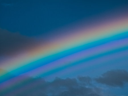 View of a rainbow in a cloudy sky. Double rainbows are a rare phenomenon.の写真素材