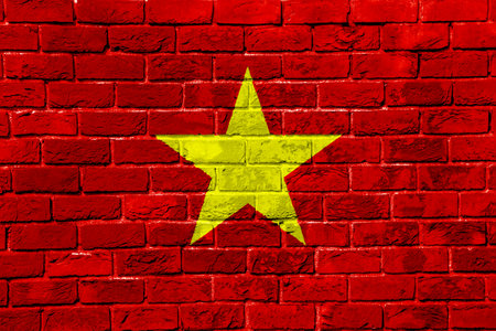 Flag of Socialist Republic of Vietnam on a textured background. Concept collage.の写真素材