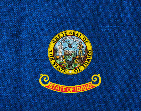 Flag of Idaho US state on a textured background. Concept collage.の写真素材
