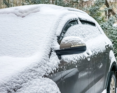 Close-up of a side mirror of a modern car covered in snowの写真素材