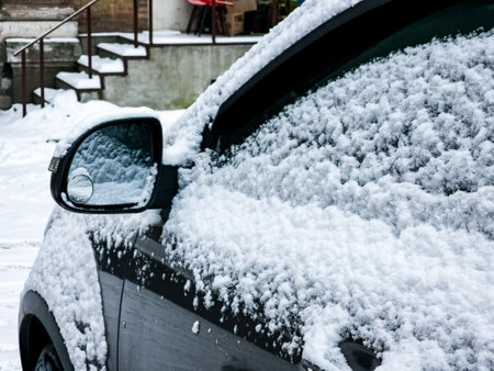 Close-up of a side mirror of a modern car covered in snowの写真素材