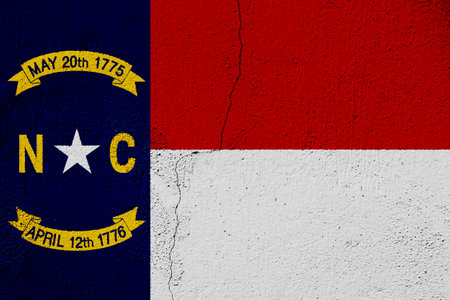 Flag of North Carolina state USA on a textured background. Concept collage.の写真素材