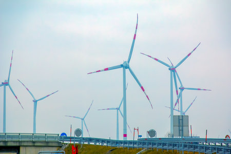Wind station turbine windmill park next to the road in Austria in cloudy weather.