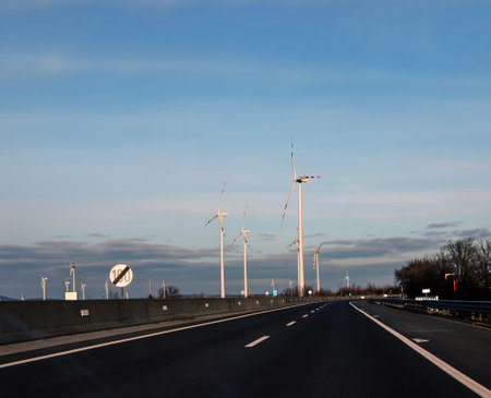 Wind farm park next to a road in Austria in sunny weather.