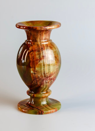 Spectacular vase made of natural onyx in orange tones. Closeup. Isolated on white.の写真素材