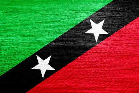 Flag of Federation of Saint Christopher and Nevis on a textured background. Concept collage.の写真素材