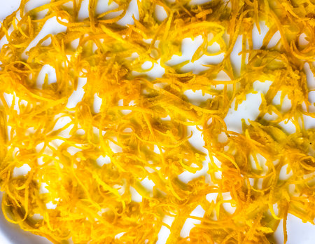 Fresh orange zest on a white plate. Raw citrus zest, gratified orange peel, fresh zest on a white background.の写真素材