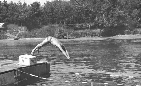 Retro photo of a young man jumping into the river. THE USSR. 70s of the 20th century.の写真素材