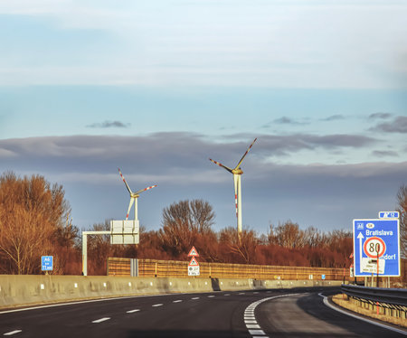 Austria, road to Vienna from Bratislava - 14/01/2024: Wind farm park next to a road in Austria in sunny weather.のeditorial素材