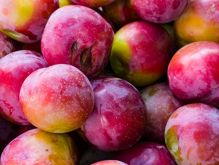 Fresh ripe plums as a background. Fruits at the farmers market. Organic products.