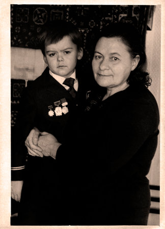 Retro portrait of a grandmother with her grandson. USSR, Ukraine, Dnepropetrovsk - circa 1972.