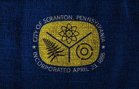 Flag of the city of Scranton, Pennsylvania, USA, on a background of fabric texture. Conceptual...