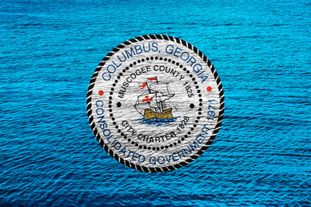 Flag of the city of Columbus, Georgia, USA, on a background of the water surface. Conceptual collage.の写真素材