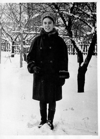 Vintage photo of a smiling girl in a winter garden. Retro photo taken in Ukraine, in the 1960s.の写真素材