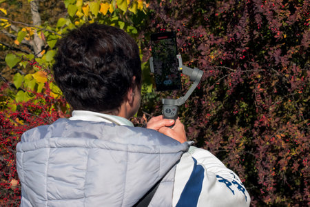 Behind the scenes. A person films nature scenes using stabilization equipment.