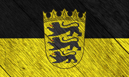 Lesser coat of arms of Baden-Wurttemberg on the national flag of Baden. Conceptual collage on wood texture.の写真素材