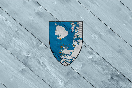 Official flag and coat of arms of Qeqertalik. Greenland. Conceptual collage on wood texture.の写真素材