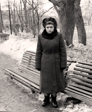 Vintage portrait of a thoughtful young girl dressed in 1950s fashion.