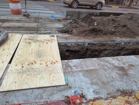 Construction work. Laying underground utilities in the city center. Crossing the ditch for laying utilities.の写真素材