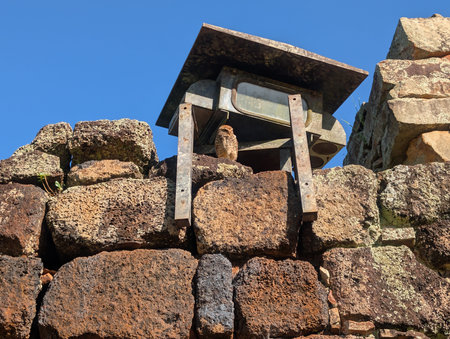An eagle owl, a bird of prey, sits on an ancient stone wall of a Jesuit church in San Ignacio, Argentina. The hunter looks out for food.の写真素材