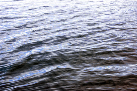 Water background of lake Traunsee in the Alps. Colorful texture of reflections of clear mountain lake. Texture of water with reflections.の写真素材