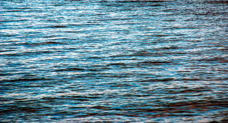 Water background of lake Traunsee in the Alps. Colorful texture of reflections of clear mountain lake. Texture of water with reflections.の写真素材
