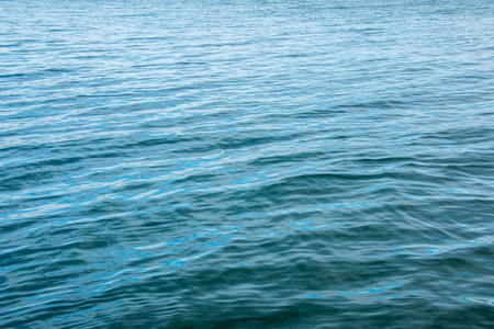 Water background of lake Traunsee in the Alps. Colorful texture of reflections of clear mountain lake. Texture of water with reflections.の写真素材