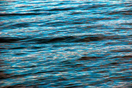 Water background of lake Traunsee in the Alps. Colorful texture of reflections of clear mountain lake. Texture of water with reflections.の写真素材