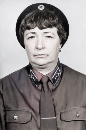 Vintage portrait of a beautiful middle-aged woman in a specialized security uniform. Retro photo,...