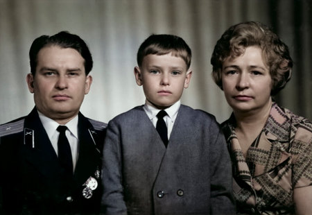 A vintage family portrait of a son, mother, and father in military uniform. Retro photograph from...