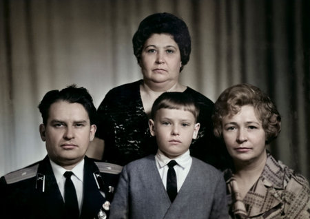 A vintage family portrait of a son, mother, father in military uniform, and mother's sister. Retro photograph from 1972.の写真素材