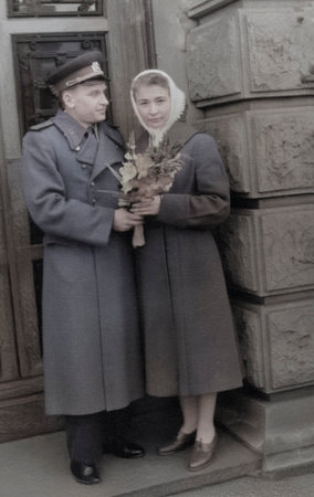 Retro portrait of a young military man giving flowers to a young woman. Vintage photo of a young...