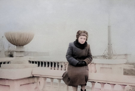 Vintage portrait of a young girl dressed in 1950s fashion in the city. Retro photo from 1955.の写真素材
