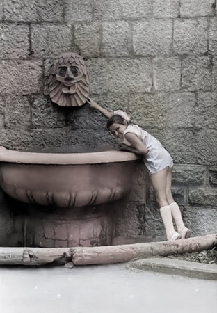 A vintage portrait of a seven-year-old girl near the Lion Fountain. Photo from 1974.の写真素材