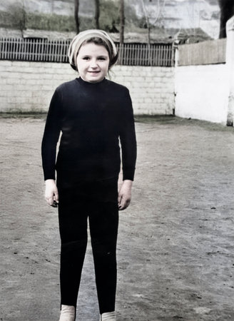 A vintage portrait of a Soviet girl in a tracksuit during an outdoor physical education class, photographed in 1974.の写真素材