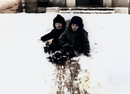 Luga, USSR - December 1, 1970: Vintage portrait of laughing young children playing in the snow in winter. Retro photo.のeditorial素材