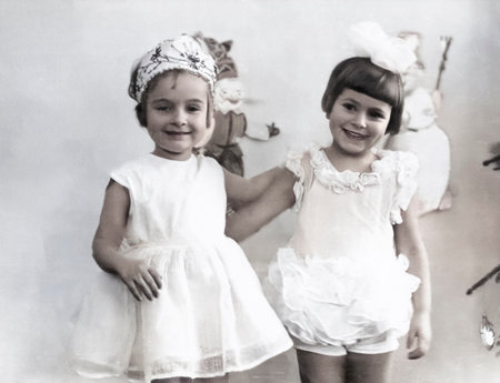 Minsk, USSR - December 27, 1974: A vintage portrait of two girls dressed as snowflakes at a New Year's party in their kindergarten. Retro photo.のeditorial素材