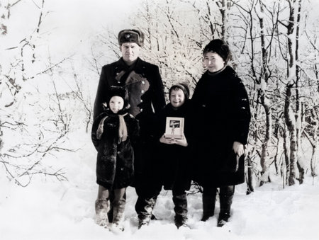 Serov, USSR - January 7, 1971: Children and their parents stroll through the snowy town. The father is a Soviet Army officer. Vintage photo.のeditorial素材