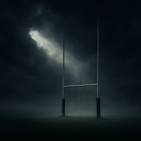 A dramatic view of rugby goal posts at night with dark, moody sky and a spotlight effect.の素材