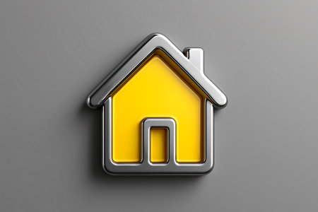A stylized, chrome-bordered house icon shines on a grey surface with bright yellow interior space.の素材