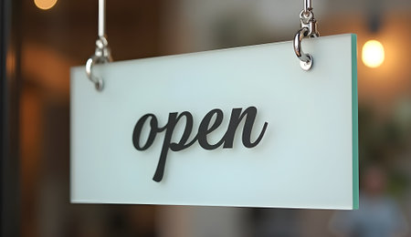 A clear sign indicates the establishment is open, with inviting script against frosted glassの素材