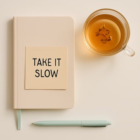 Top-down view depicts a self-care scene with a wellness journal, herbal tea, and a calming pen.の素材