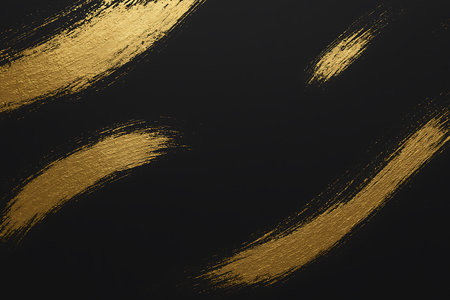 Abstract black background featuring dynamic strokes of textured gold paint for an elegant design.の素材