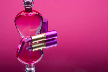 Small still life of bottles of perfume and lipstickの写真素材