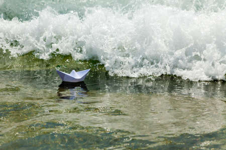 Paper boat and sea foam waveの写真素材