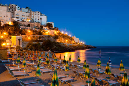 Evening view of the beach and the rock on which the beautiful Italian city of Sperlongaの写真素材