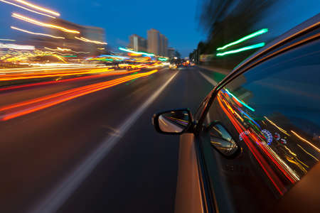 Car driving fast in the night city